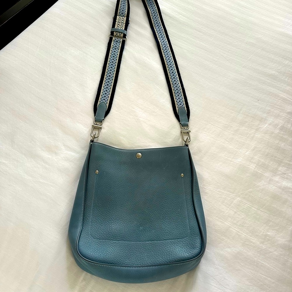 Light blue leather Shinola “Pocket Crossbody” bag w/patterned adjustable strap